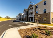 Thumbnail 15 of 55 - A row of modern apartment buildings with a clear blue sky above.