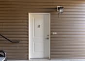 Thumbnail 25 of 55 - A white door with a black handle is on a brown wall.