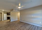 Thumbnail 29 of 55 - A room with a ceiling fan and wooden flooring.