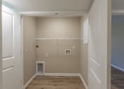 Thumbnail 46 of 55 - A room with a white door and a white closet with a white shelf.