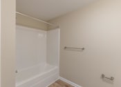 Thumbnail 49 of 55 - A white bathtub in a small bathroom.