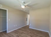 Thumbnail 38 of 55 - A room with a ceiling fan and wooden flooring.