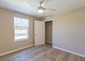 Thumbnail 37 of 55 - A room with a ceiling fan and a window with blinds.