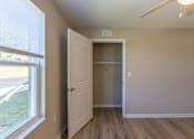 Thumbnail 36 of 55 - A room with a white door and a window with blinds.