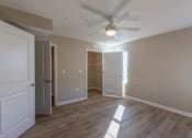 Thumbnail 39 of 55 - A room with a ceiling fan and light fixture, and a door to the left.