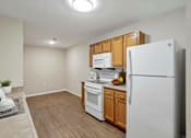 Thumbnail 31 of 31 - A kitchen with white appliances and wooden cabinets.