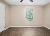 Thumbnail 3 of 72 - an empty living room with wood floors and a window