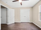 Thumbnail 7 of 72 - an empty living room with two doors and a ceiling fan