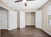 Thumbnail 8 of 72 - an empty bedroom with a closet and a ceiling fan