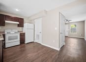 Thumbnail 11 of 72 - an empty kitchen with white appliances and wood floors