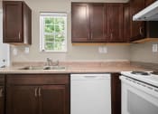Thumbnail 17 of 72 - a kitchen with white appliances and wooden cabinets