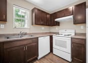 Thumbnail 16 of 72 - a kitchen with white appliances and dark wood cabinets