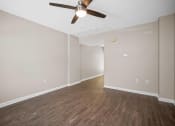Thumbnail 20 of 72 - a living room with wood floors and a ceiling fan
