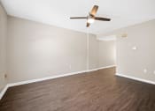 Thumbnail 18 of 72 - a living room with wood floors and a ceiling fan