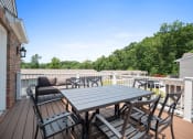 Thumbnail 23 of 72 - a patio with a table and chairs on a deck