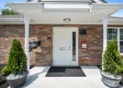 Thumbnail 28 of 72 - the entrance to a brick building with a white door