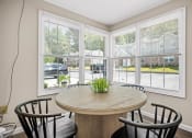 Thumbnail 29 of 72 - a dining room with large windows and a table with chairs