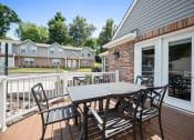 Thumbnail 22 of 72 - a patio with a table and chairs on a deck