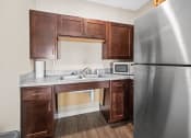 Thumbnail 34 of 72 - a kitchen with stainless steel appliances and wooden cabinets