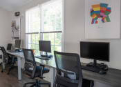 Thumbnail 41 of 72 - a computer room with desks and chairs and a window