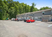 Thumbnail 43 of 72 - a parking lot with cars in front of a building