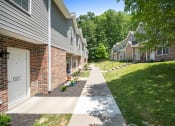 Thumbnail 57 of 72 - a sidewalk in front of a row of apartment buildings