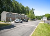 Thumbnail 60 of 72 - a street with cars parked in front of houses