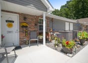 Thumbnail 63 of 72 - the front porch of a house with a patio and a white door