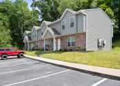 Thumbnail 64 of 72 - a house with a red truck parked in a parking lot