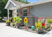 Thumbnail 67 of 72 - a yard with potted plants and flowers in front of a house
