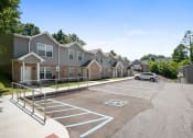 Thumbnail 51 of 72 - an empty parking lot in front of a row of houses