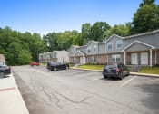 Thumbnail 52 of 72 - a parking lot with cars parked in front of houses