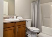 Thumbnail 44 of 45 - A white toilet sits next to a sink in a bathroom.