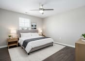 Thumbnail 25 of 25 - A bedroom with a bed, nightstands, and a ceiling fan.