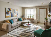 Thumbnail 21 of 24 - A living room with a grey couch, a green chair, and a coffee table.