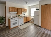 Thumbnail 22 of 24 - A kitchen with wooden cabinets and a white fridge.