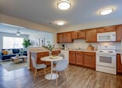 Thumbnail 25 of 28 - A kitchen with wooden cabinets and white appliances.