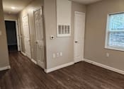 Thumbnail 4 of 30 - A room with wood flooring and white walls.