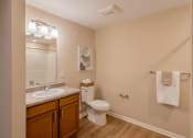 Thumbnail 32 of 32 - A bathroom with a toilet, sink, and towel rack.