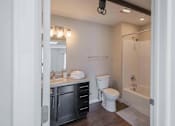 Thumbnail 36 of 39 - A bathroom with a white toilet and a white sink.