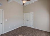 Thumbnail 16 of 39 - A room with a carpeted floor and a ceiling fan.