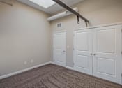 Thumbnail 33 of 39 - A room with a carpeted floor and a white door.
