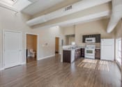 Thumbnail 15 of 39 - A kitchen with white appliances and wooden floors.