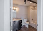 Thumbnail 17 of 39 - A bathroom with a white toilet and a white sink.
