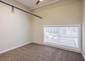 Thumbnail 20 of 39 - A room with a window covered by white blinds.