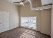 Thumbnail 18 of 39 - A room with a ceiling fan and a window with blinds.