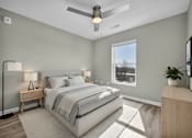 Thumbnail 17 of 18 - A bedroom with a bed, nightstand, and a ceiling fan.