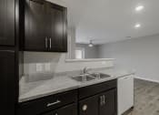 Thumbnail 18 of 38 - a kitchen with a sink and cabinets and a window