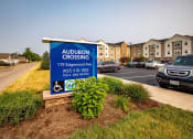 Thumbnail 46 of 48 - a sign in a parking lot with a building in the background