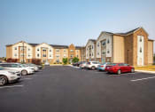 Thumbnail 38 of 48 - a parking lot in front of a building